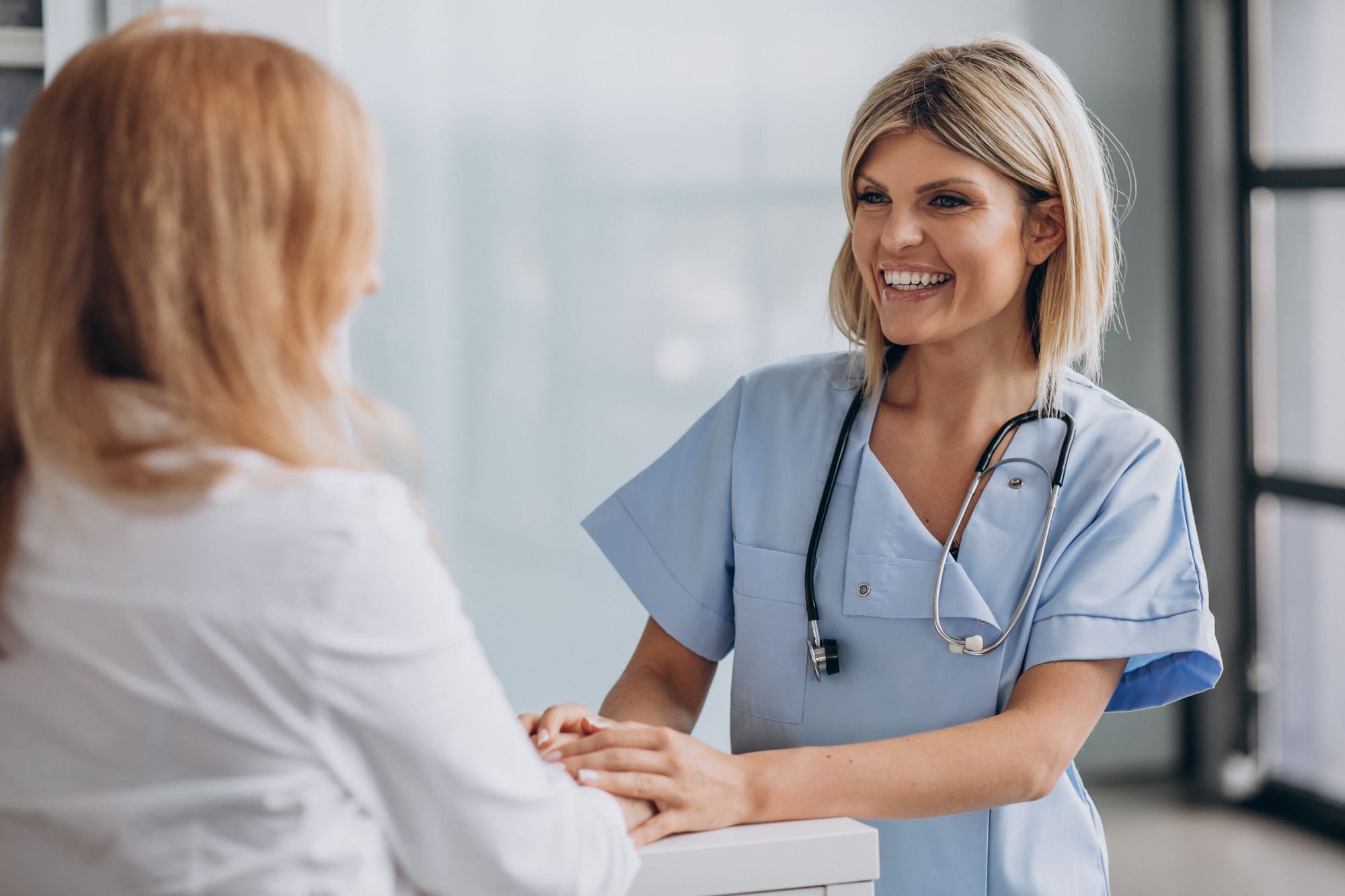 Young female doctor with patient clinic